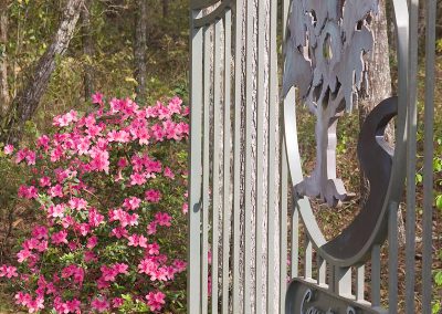 Metal Gate with Country Road Farm's logo on it.